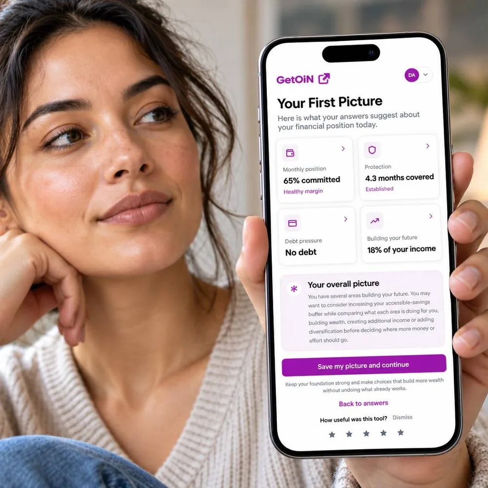 Woman holding a phone showing her GetOiN First Picture: 65% committed and 4.3 months of protection covered