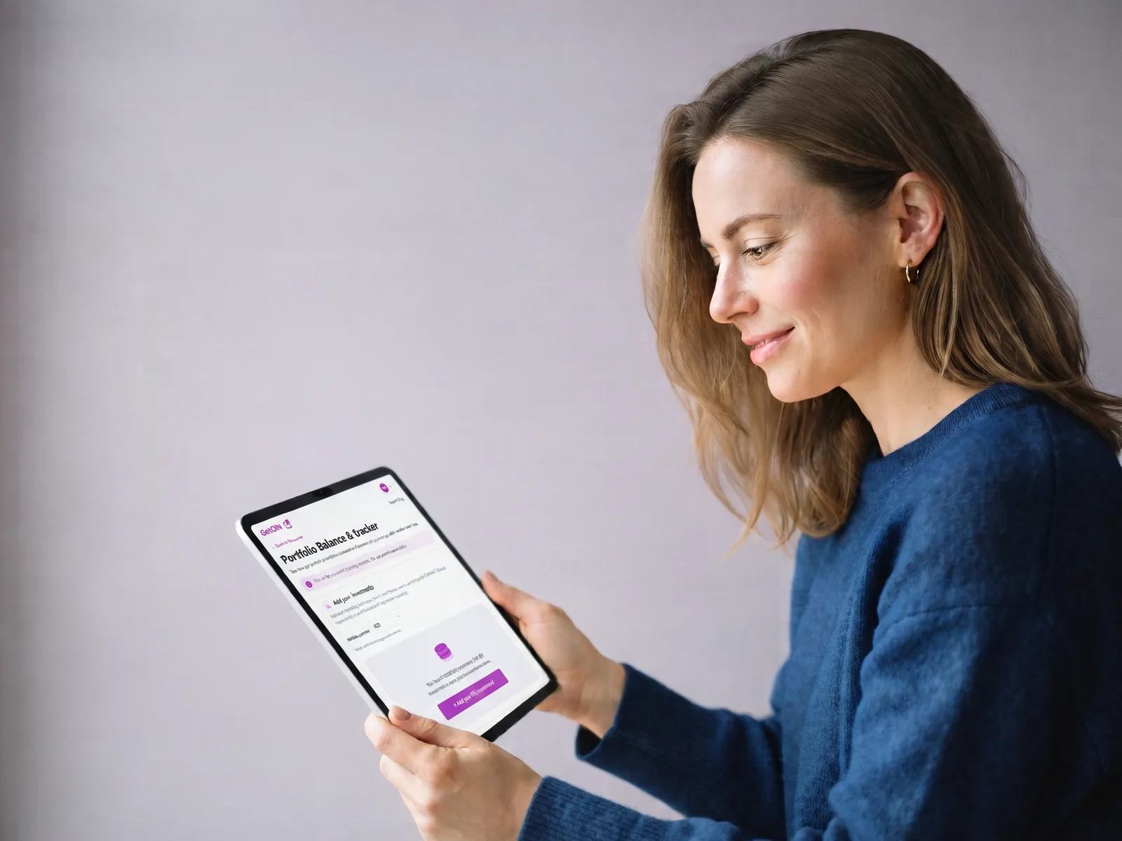 Woman reviewing the GetOiN Portfolio Balance & Gains Tracker on her tablet